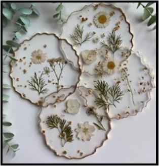 Decorative resin coasters with pressed flowers and gold accents.
